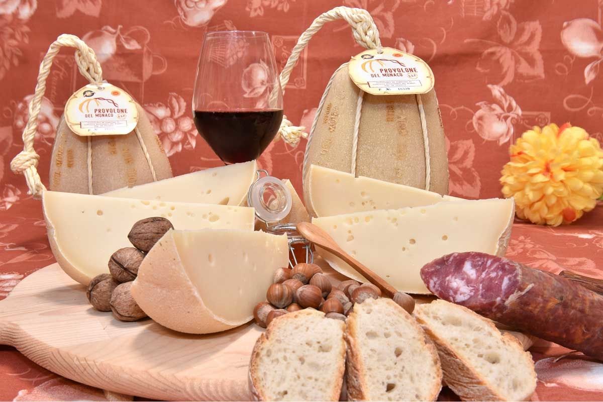 A wheel of Provolone del Monaco DOP cheese being aged
