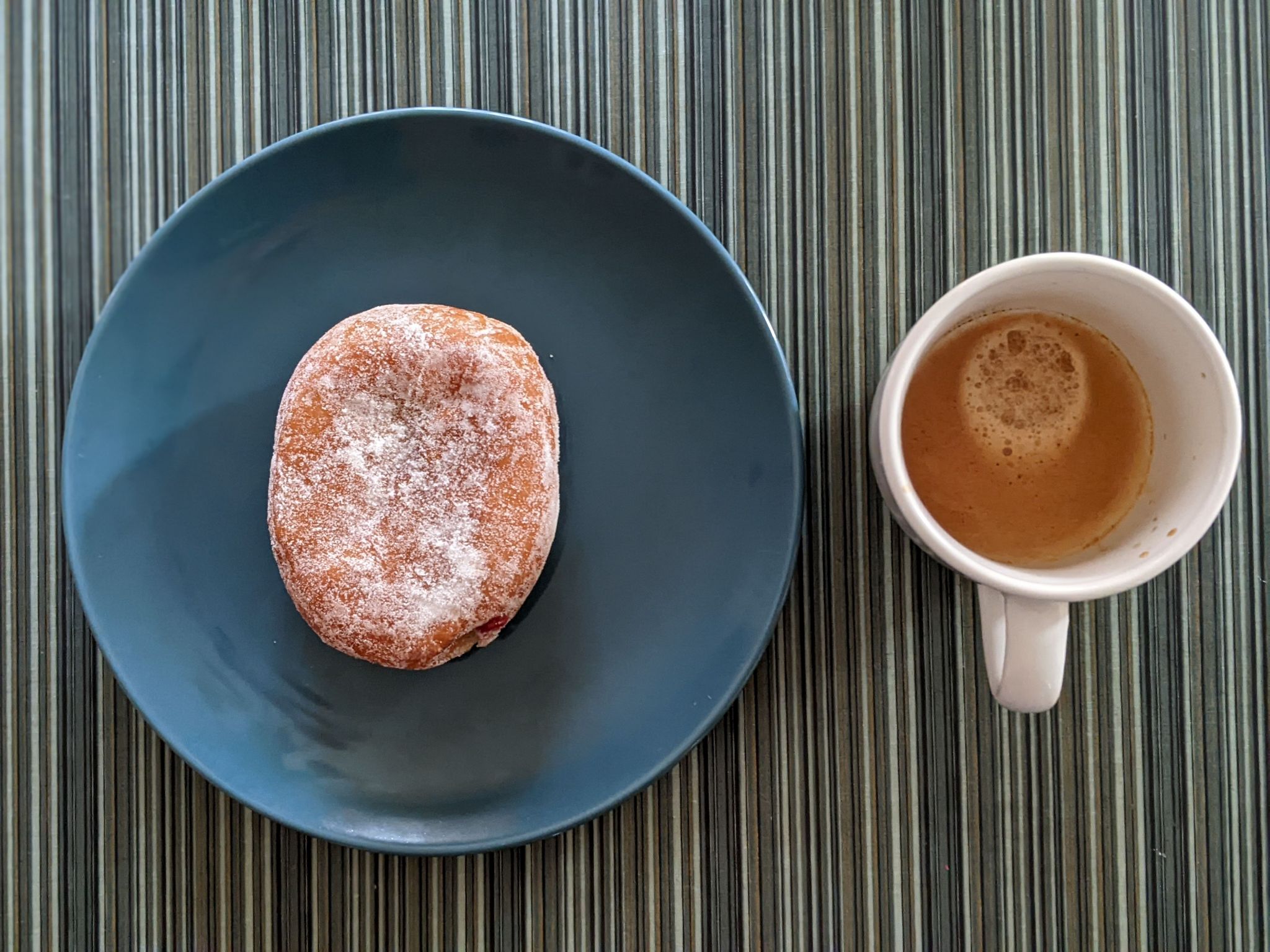 Enjoying a jelly donut and a double on a busy Friday morning