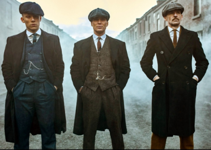 Just started up Peaky Blinders so: 
Past the square, past the bridge
Past the mills, past the stacks
On a gathering storm
Comes a tall handsome man
In a dusty black coat with
A red right hand