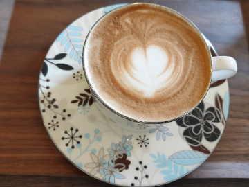 Cafè latte of chocola blend in a small local café which is full of the coffee aroma and which seems popular among local people including other café. 
