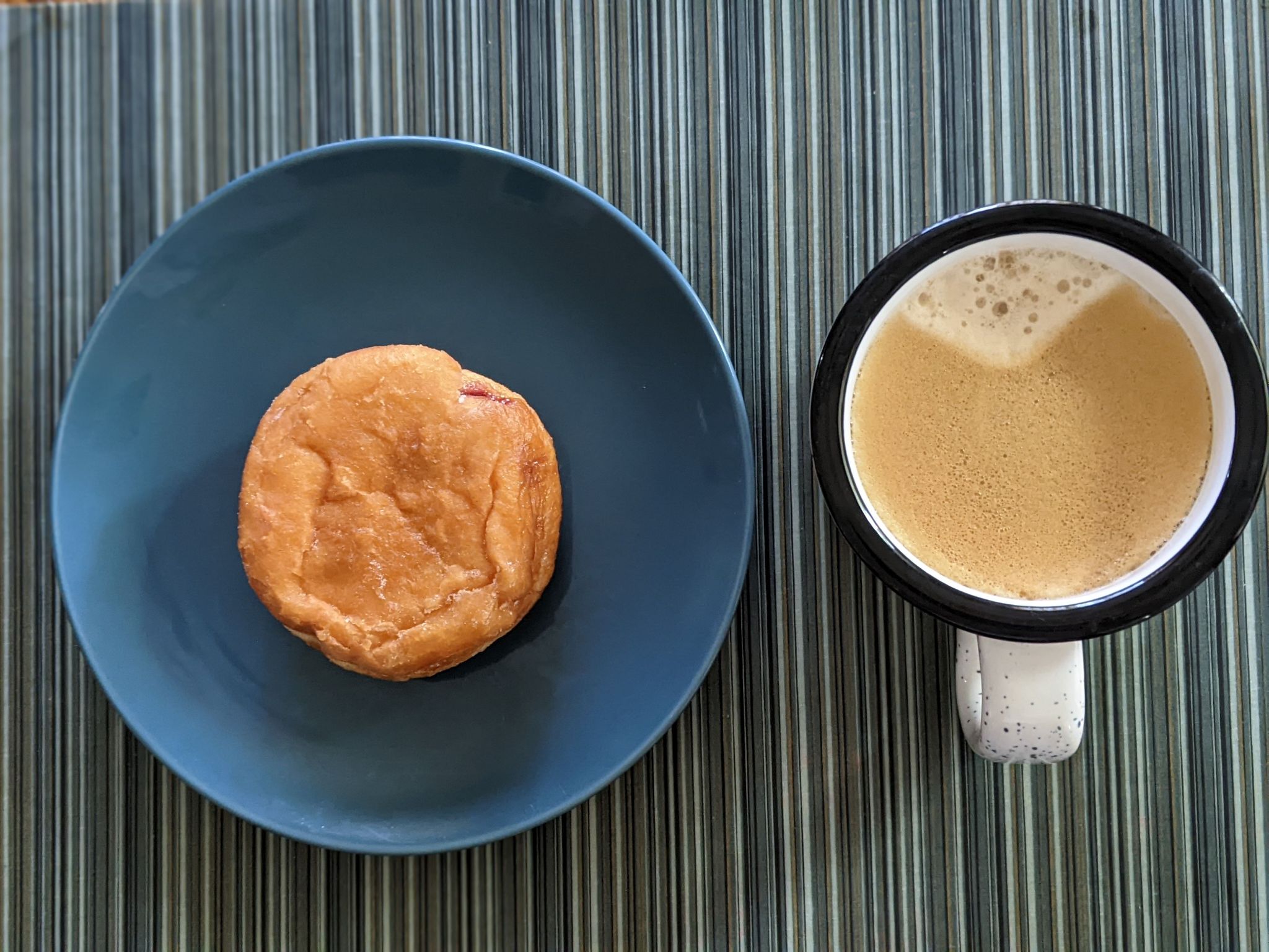 Enjoying a jelly donut with coffee on a cold Sunday morning