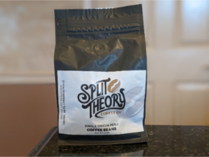 Enjoying a cup of Split Theory coffee with a granola bar before work.