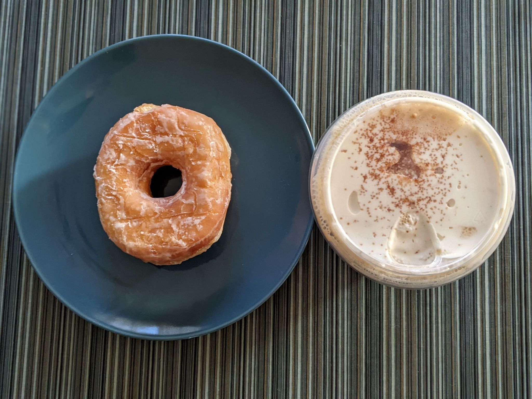 Enjoying a Dunkin Donut with a pistachio cold cream nitro cold brew with brown butter topping