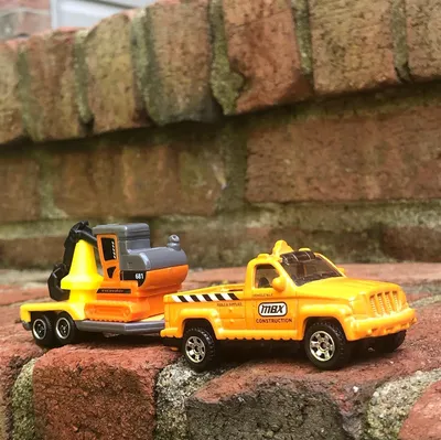 Matchbox construction truck with an excavator on the trailer. Also comes with some not-to-scale cones that make everythi