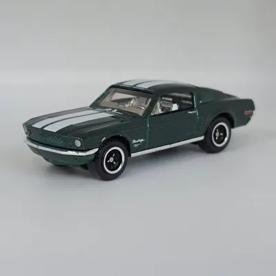 2026 Matchbox Movie No. 7/12 is the 1968 Ford Mustang Fastback. Metalflake dark green with white racing stripes. This cl