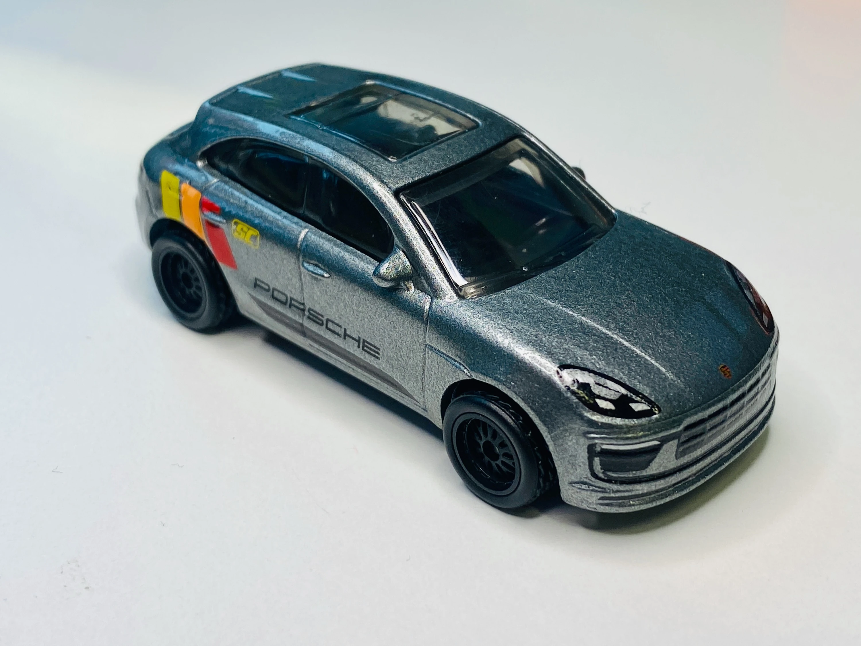Porsche Macan (Metalflake Blueish Silver, Front and rear trim details. 'PORSCHE',…)