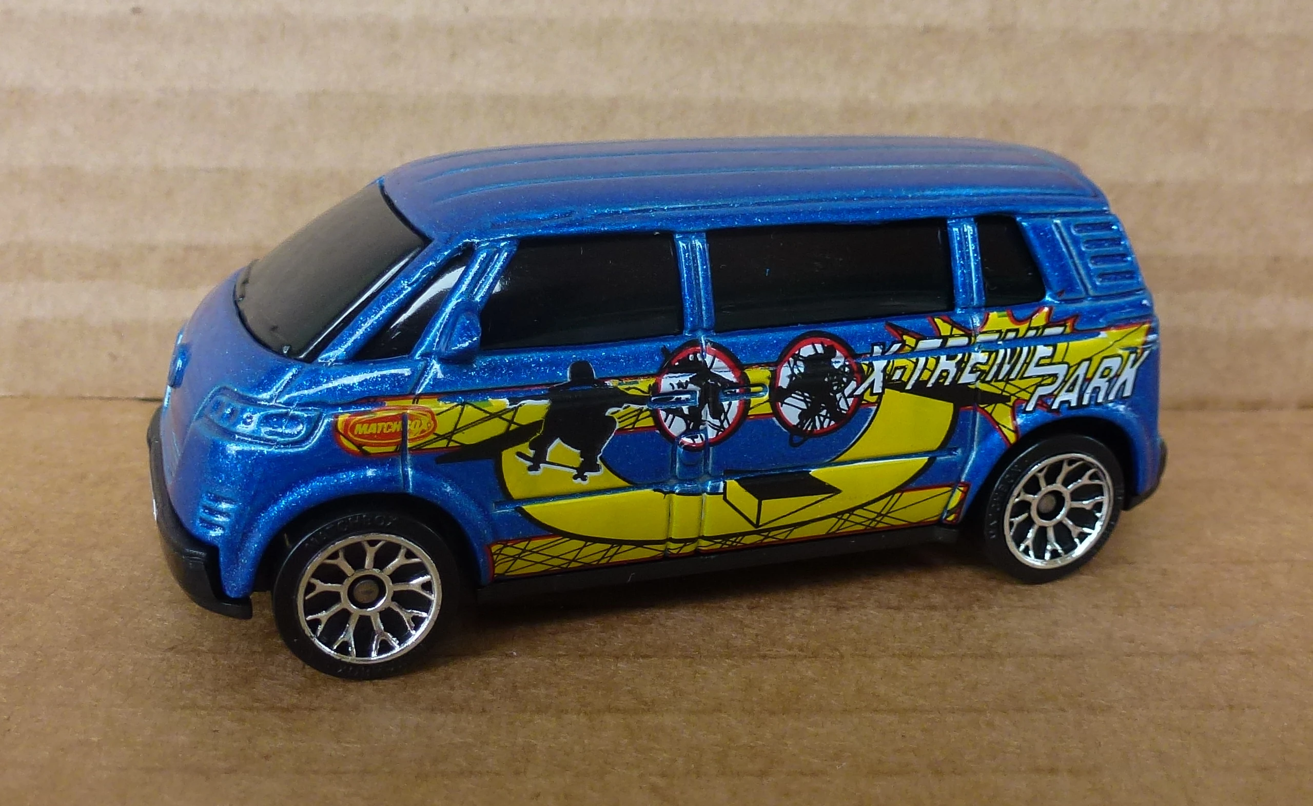 Volkswagen Microbus (Metallic dark blue, X TREME PARK on side. Yellow skateboard…)