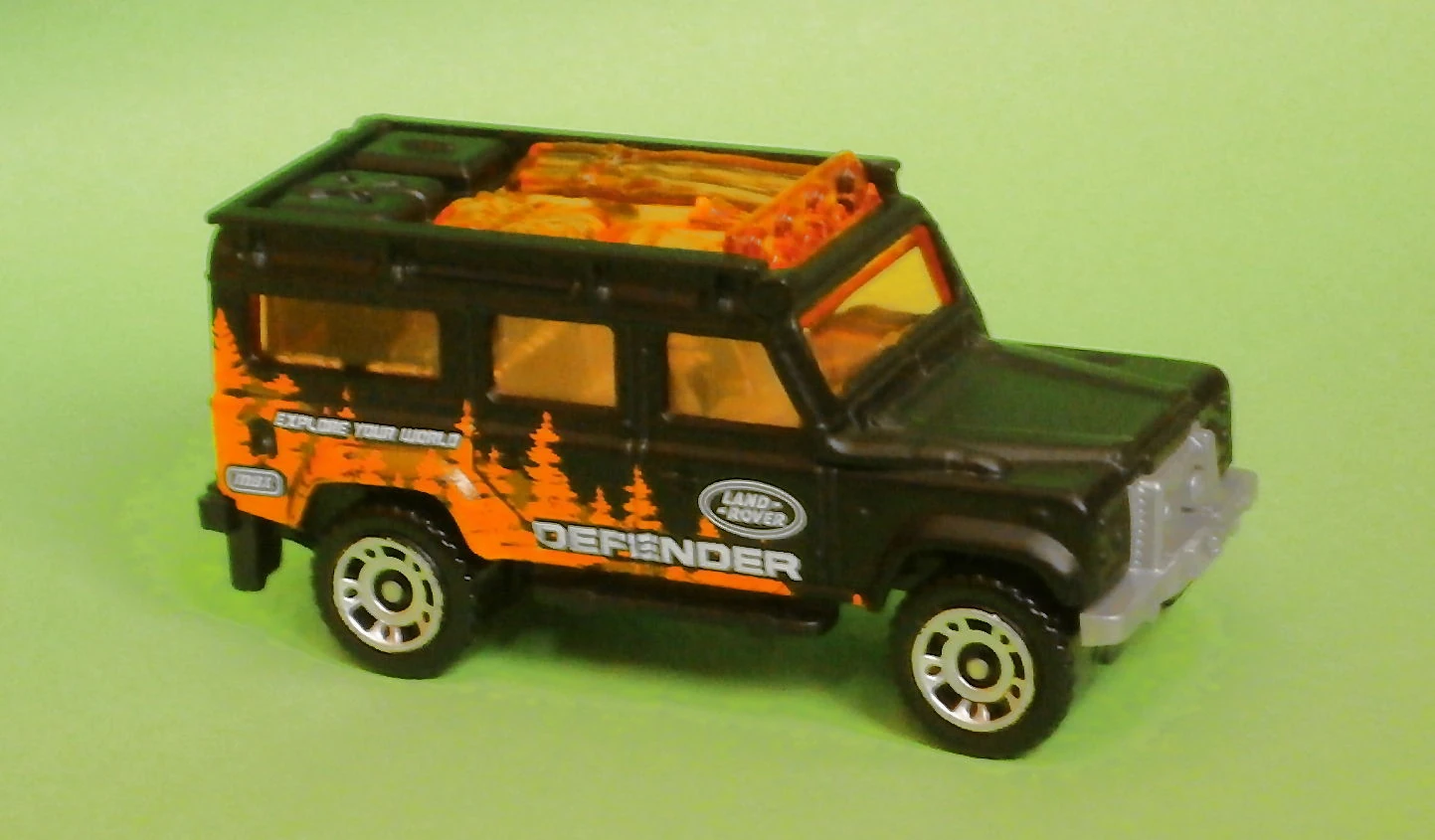 Land Rover Defender 110 (1997) (Matte Black, Forest scenery, logo, DEFENDER, EXPLORE…)