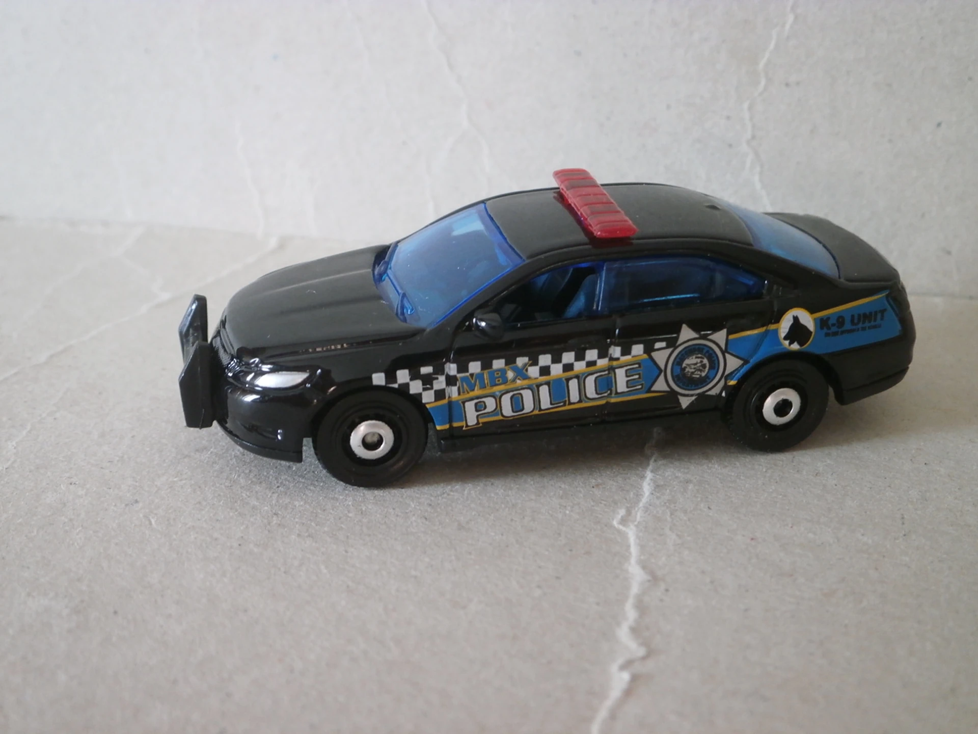Ford Police Interceptor (Black, MBX POLICE, Blue stripe along sides, K-9…)