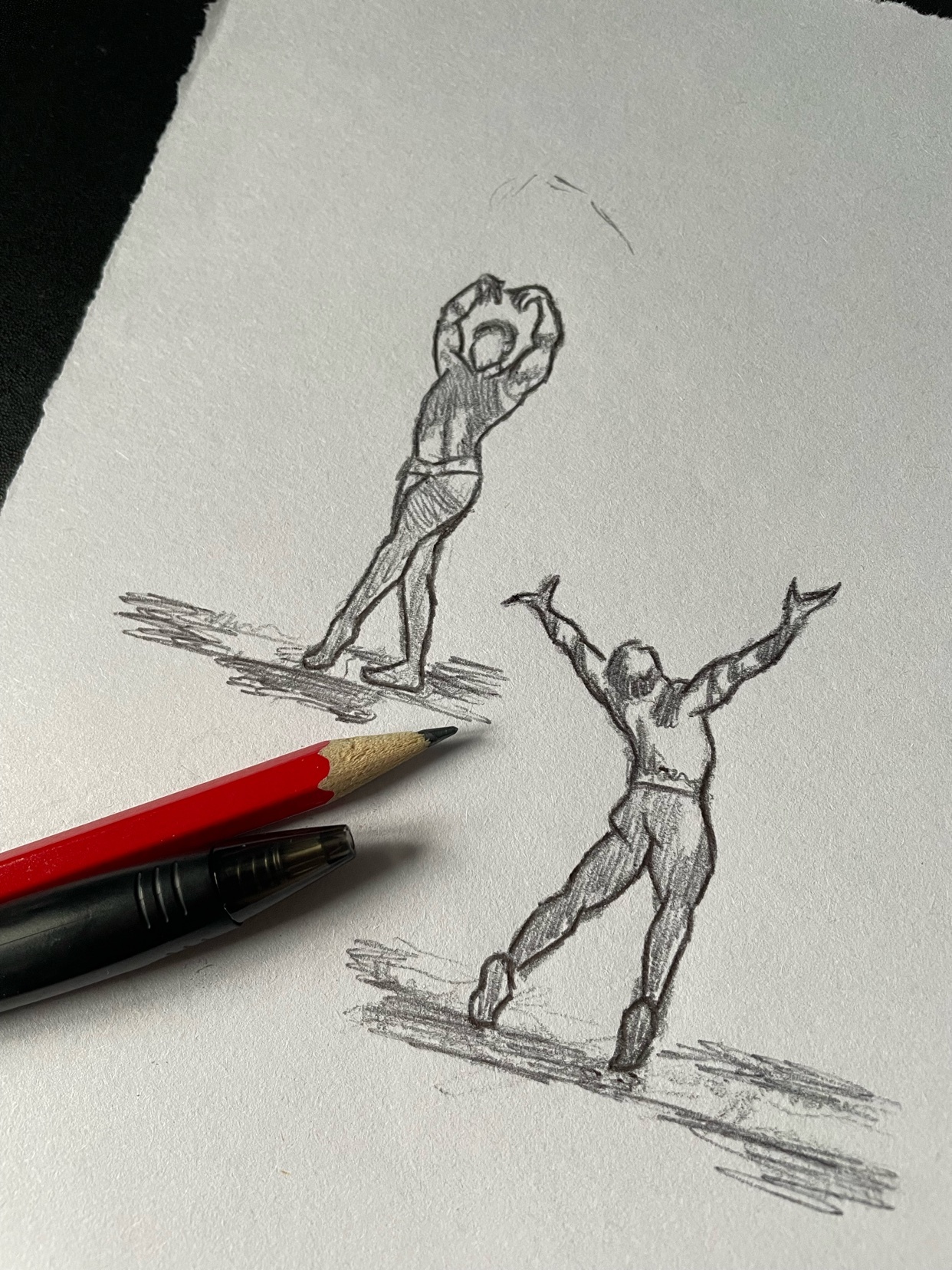 A pencil sketch of two male figures in dynamic poses. The figures are shirtless, emphasizing their muscular builds.