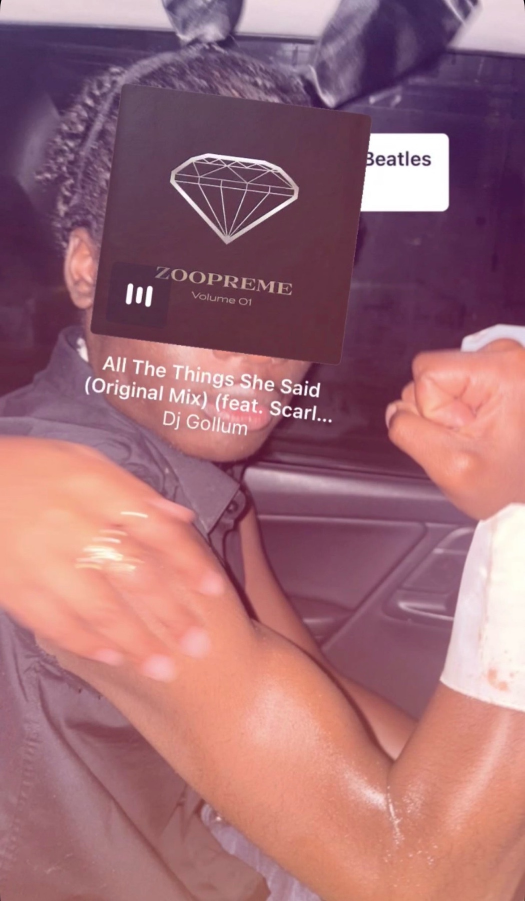 A man is shown with a music album cover over his face. The album art is for "Zoopreme Volume 01" and the song is "All The Things She Said".