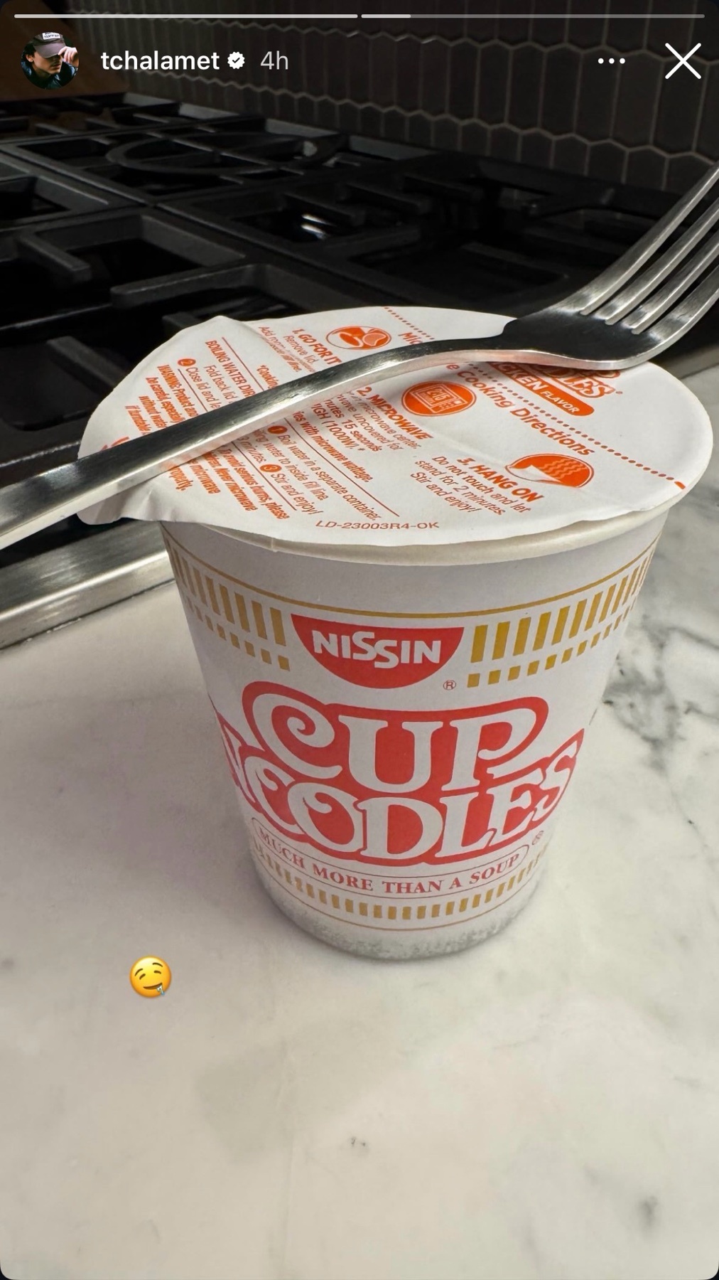A close-up shot of a cup of Nissin Cup Noodles with a fork resting on top. The image is a meme, humorously referencing the level of poverty.