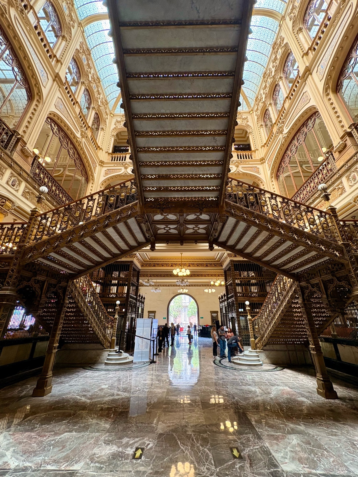 A stunning interior shot of a grand building with intricate architectural details. The image showcases a beautiful staircase and ornate design.
