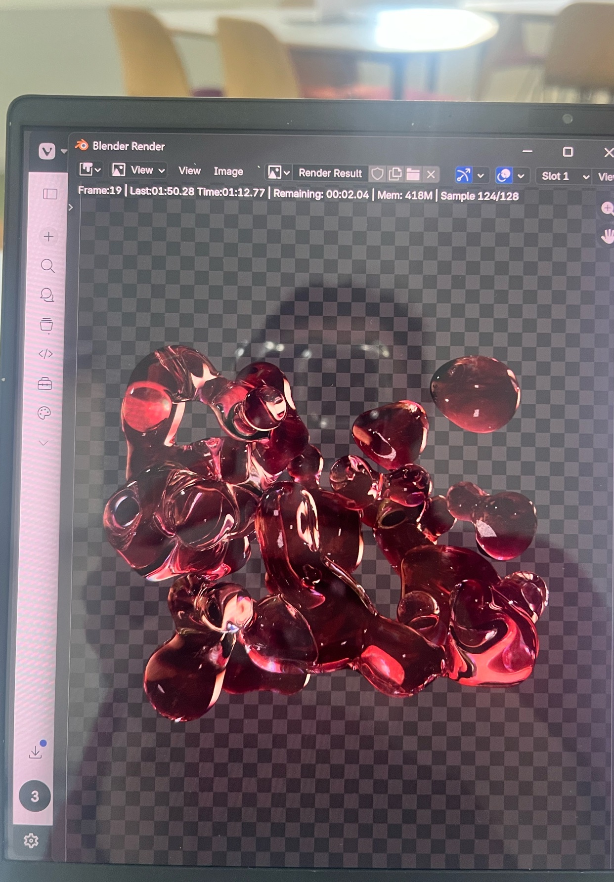 A computer screen displays a 3D rendering of abstract, liquid-like red shapes against a transparent, checkered background. The rendering appears to be created in Blender, with the software's interface visible on the screen.