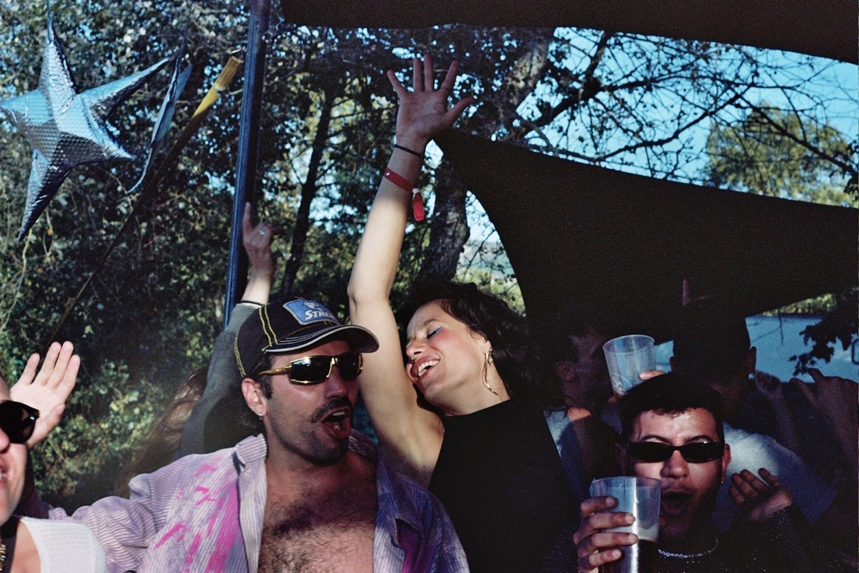 A group of friends are enjoying a party outdoors. The photo captures a moment of joy and celebration.