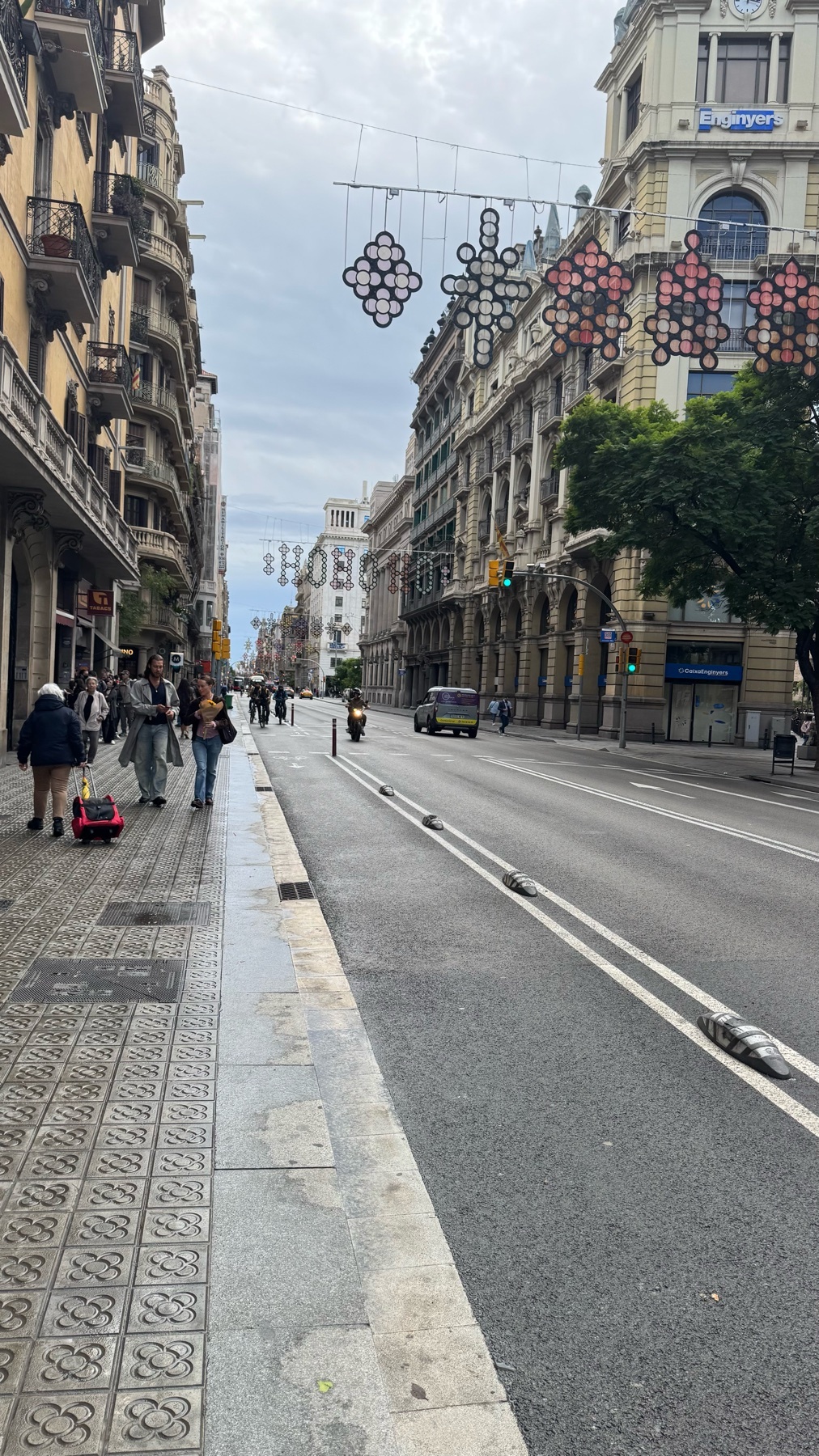 A street scene in Barcelona on a rainy day. The photo captures the architecture and urban environment of the city.