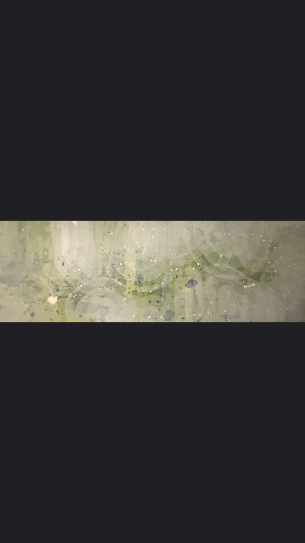An abstract, organic pattern with swirling lines and small dots, rendered in shades of green and white, suggesting a microscopic view of living layers.