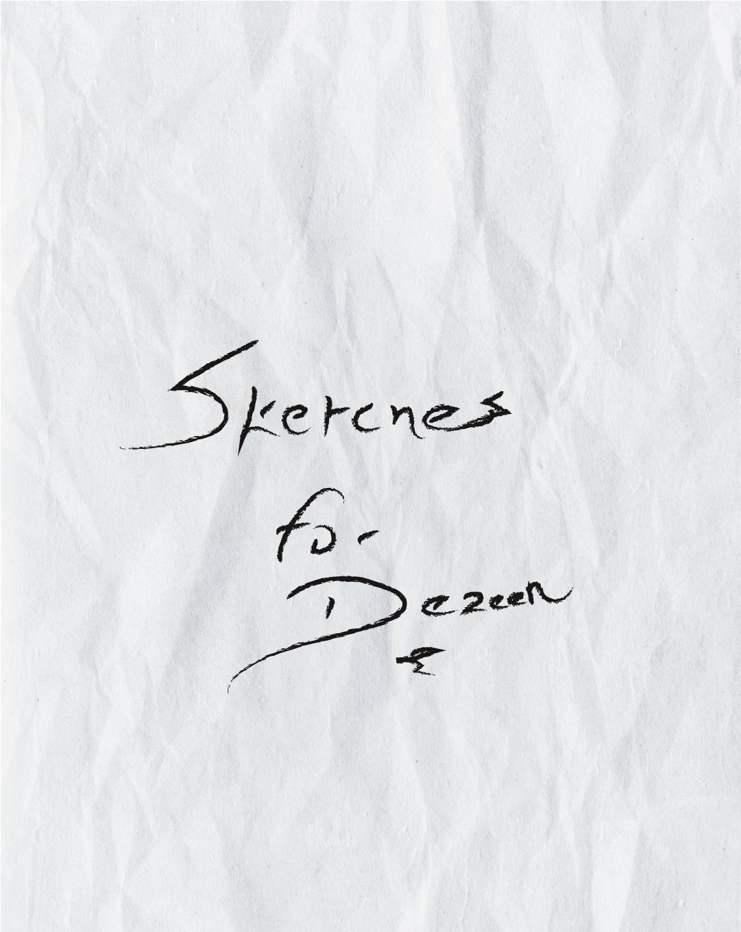 A close-up shot of a piece of paper with the words "Sketches for Dezeen" written on it. The paper is white and crumpled.