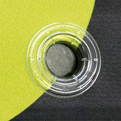 Close-up of a clear plastic eyelet on a 440gsm standard PVC vinyl banner with clean, weld-finished edges and no visible stitching.