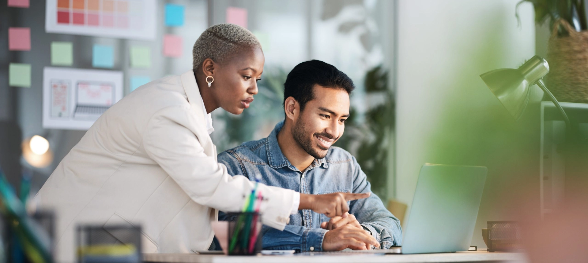 a man and woman looking at a laptop