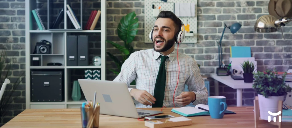 a man wearing headphones and sitting at a desk