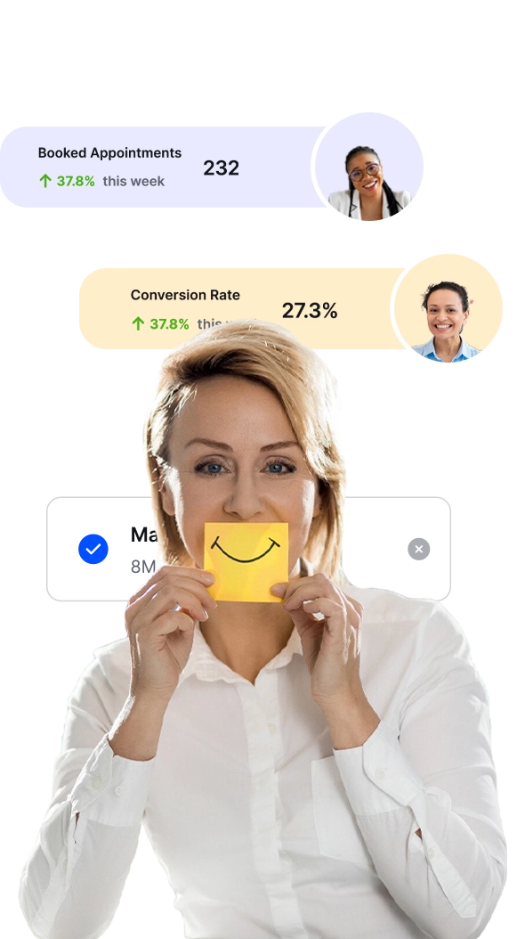 a woman holding a yellow paper with a smiley face