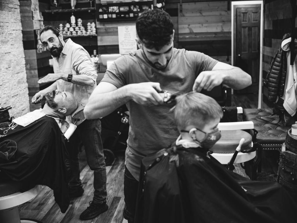 What is the proper technique for holding and angling the straight razor during shaving?