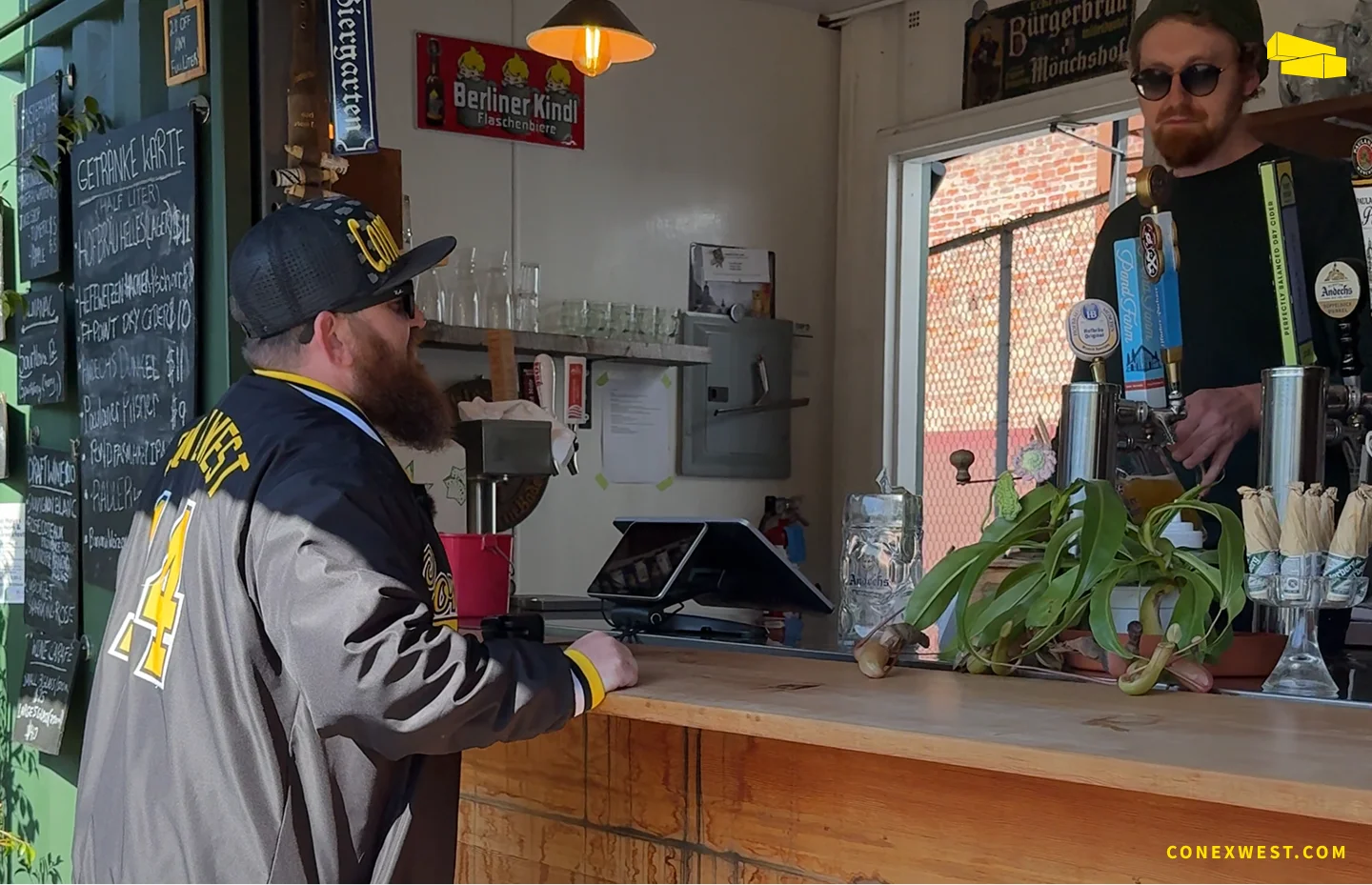 Conex Mike ordering a beer at the container-built walk-up bar at Biergarten