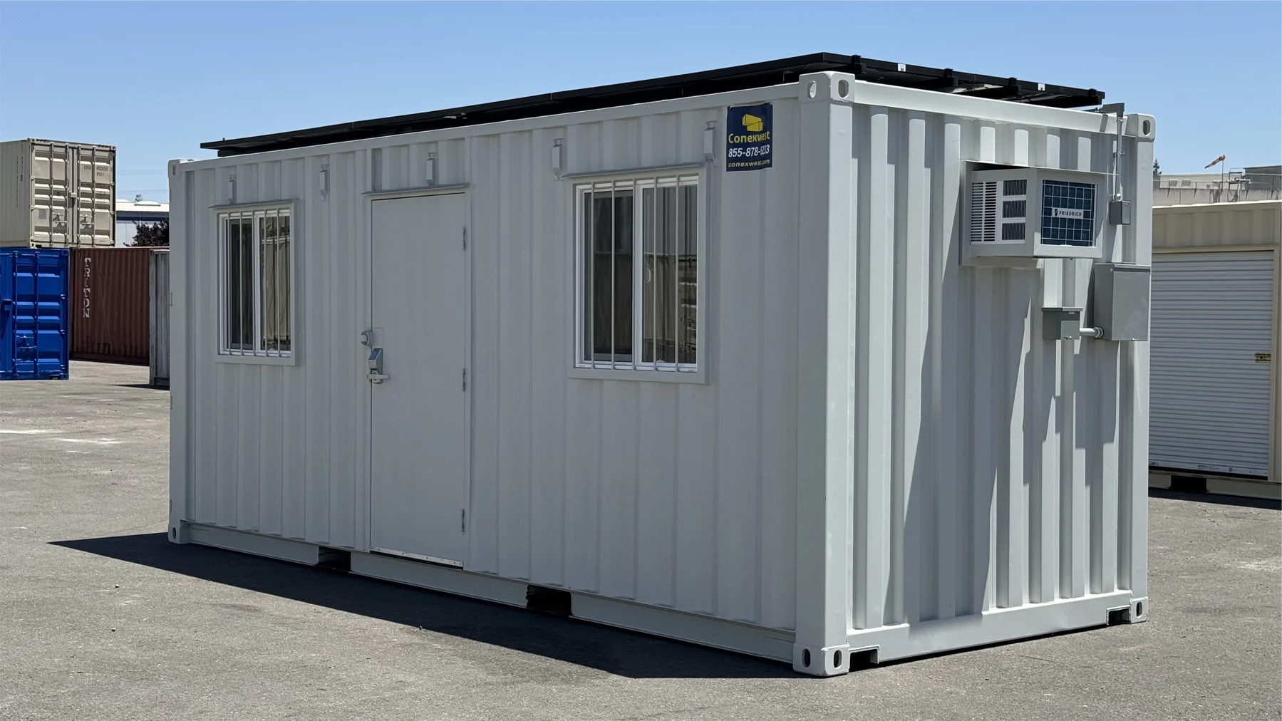 Solar-powered shipping container with roof-mounted panel array attached to a raised structural frame