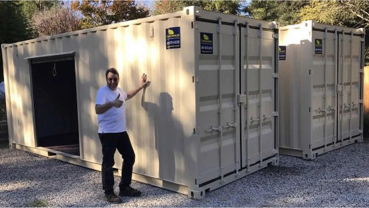 A man beside a shipping container.