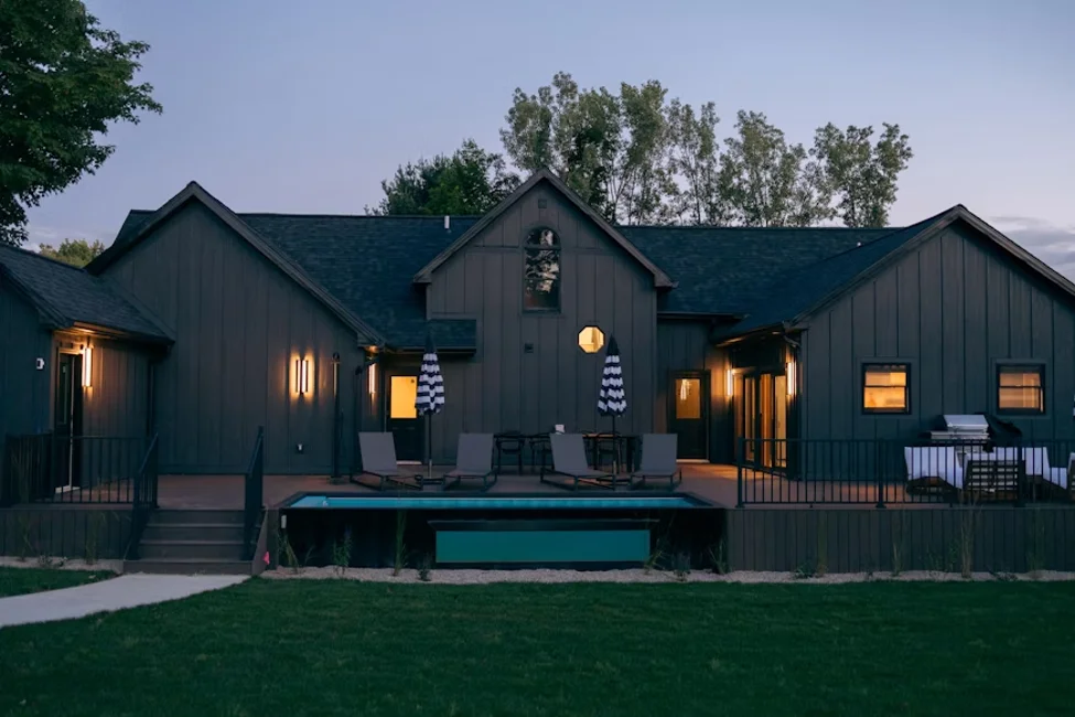 A shipping container house with modern exterior finishes and outdoor living space.