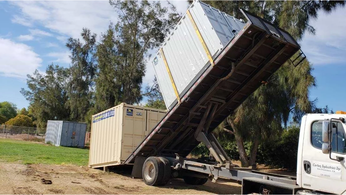 A trailer delivering a container.