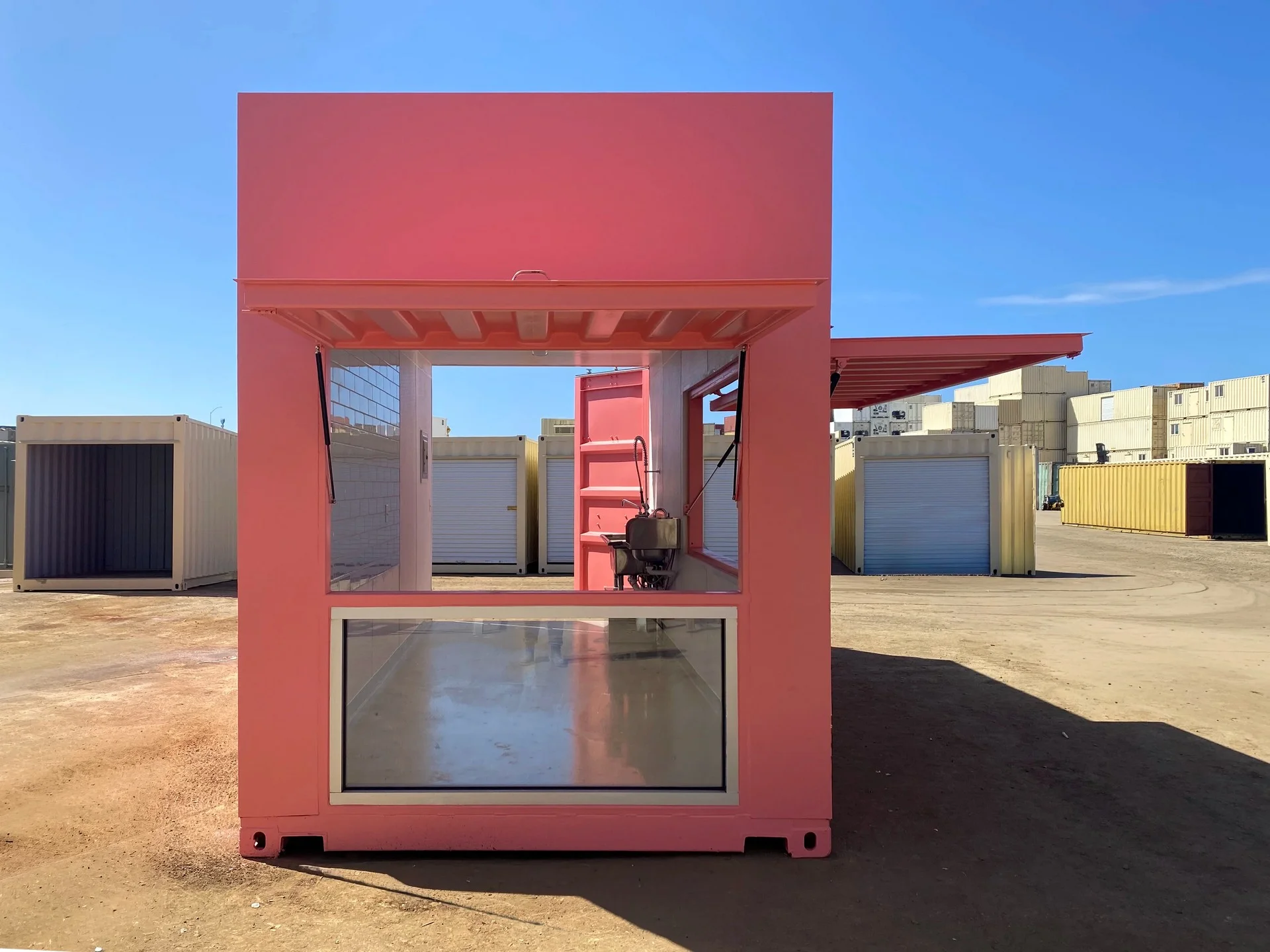 Custom shipping container cafe interior with sink, lighting, and service-ready layout