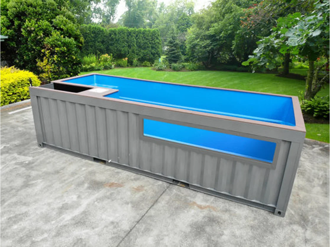 Rectangular shipping container pool with a built-in spa section and large viewing window on the side.