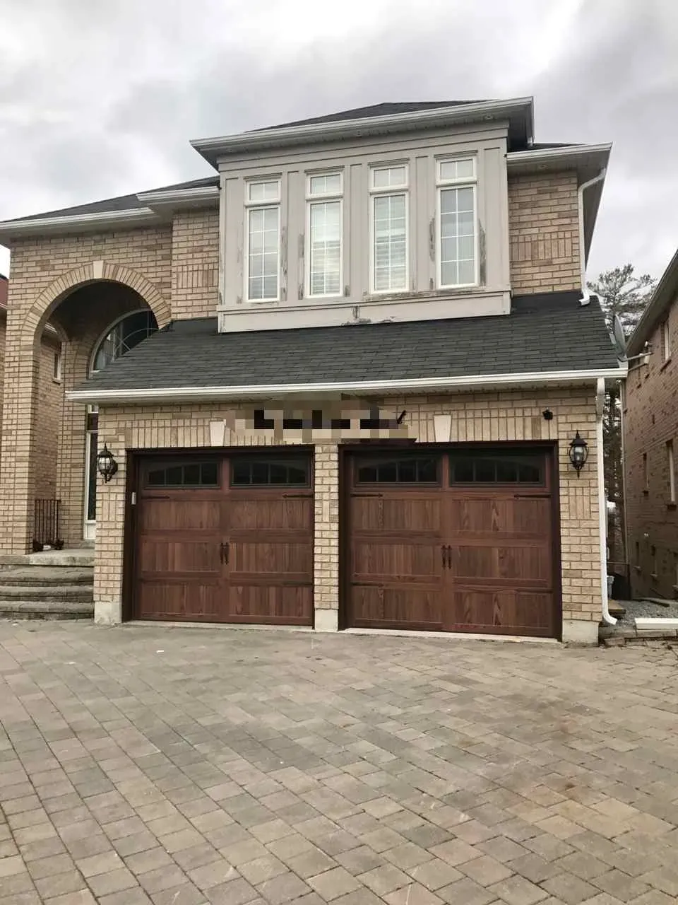 Homeowner replacing a damaged weather seal on a garage door