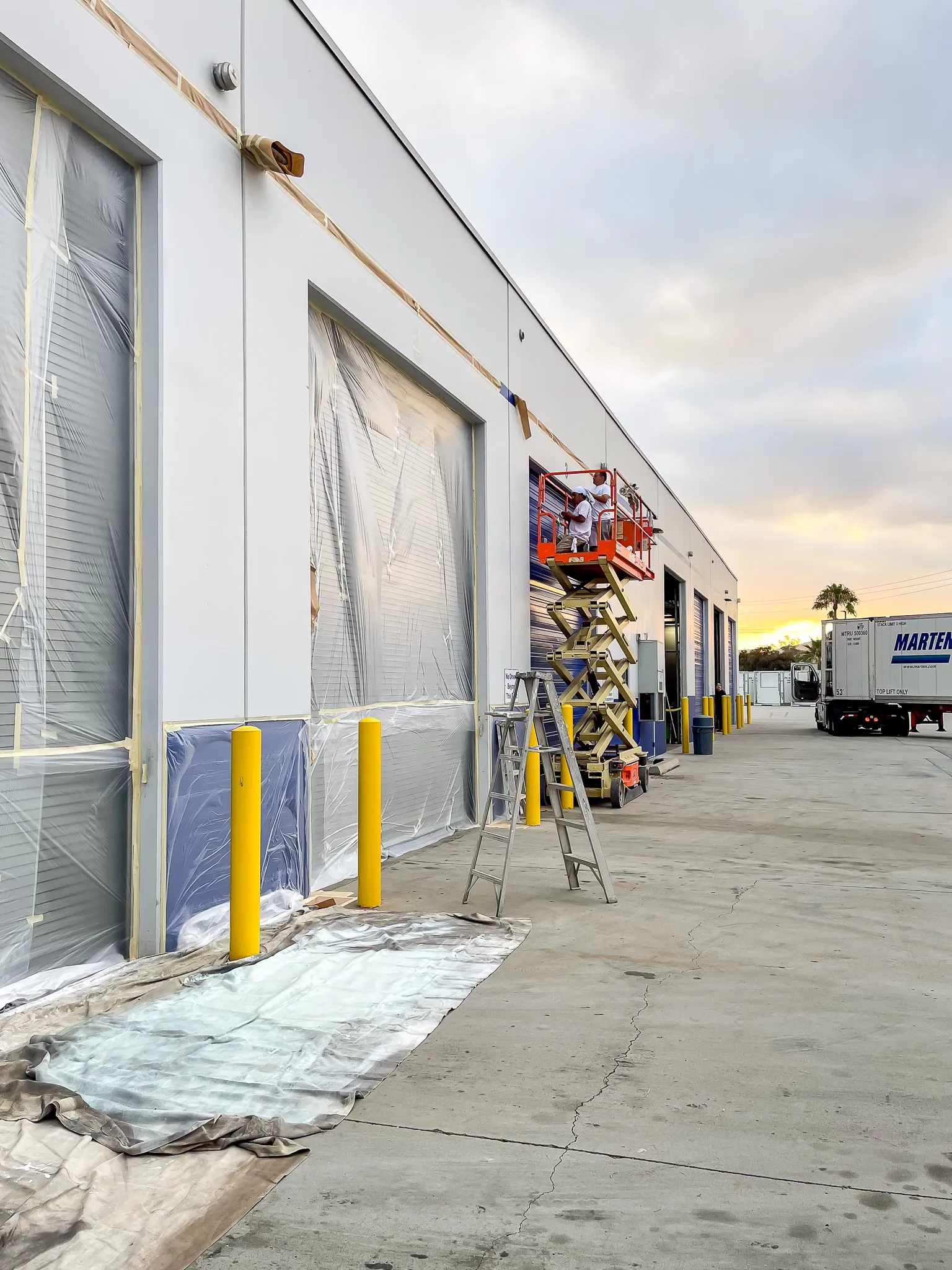 Professional painters working on a house exterior in Riverside, California
