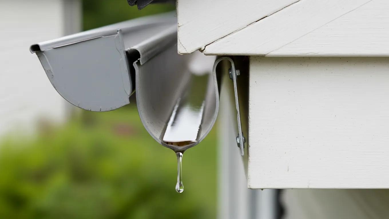 Close-up of a gutter gap caused by a sagging section pulling away from the house Close-up of a gutter gap caused by a sagging section pulling away from the house