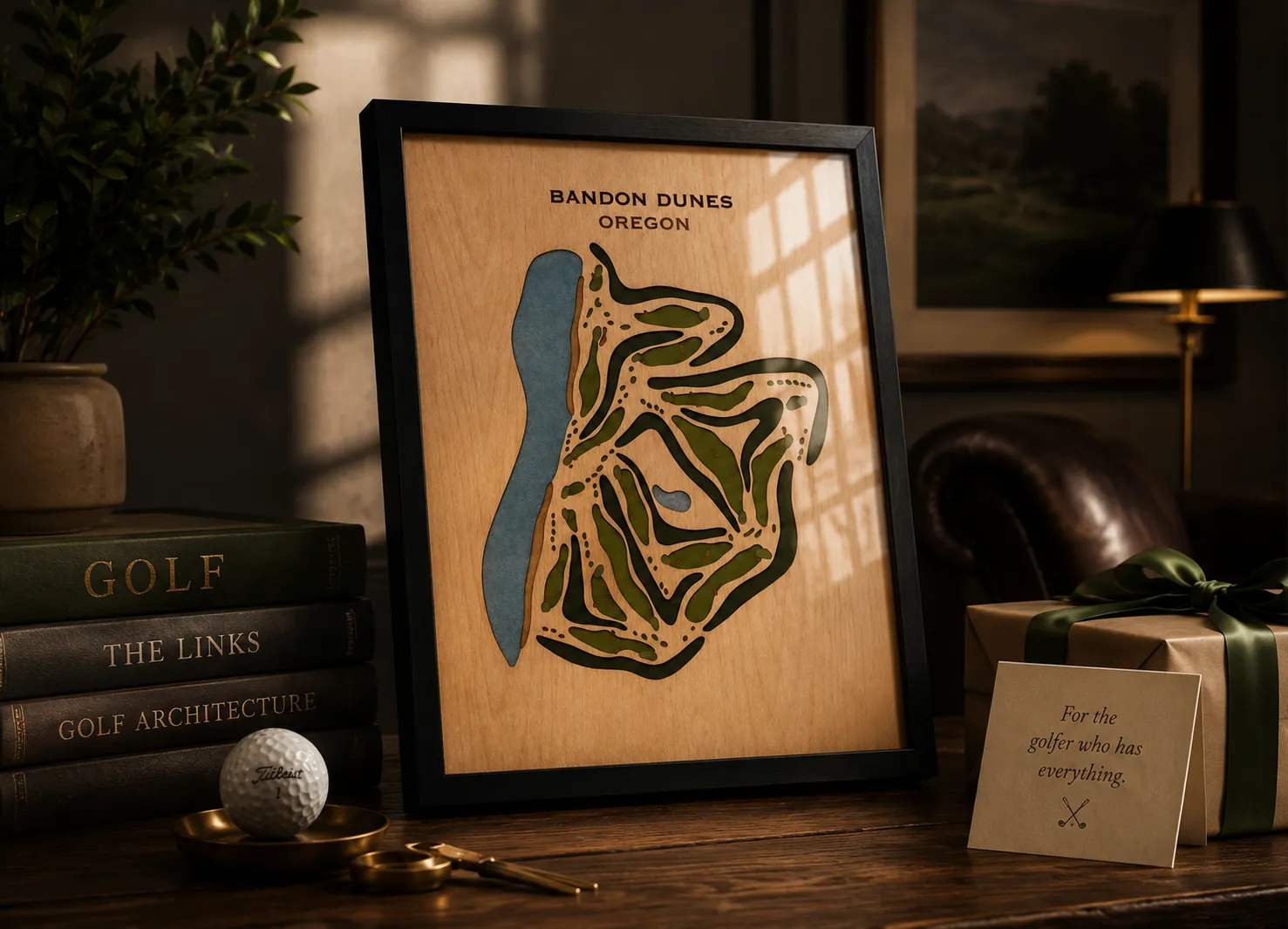 Framed map of Bandon Dunes golf course with decorative elements and books