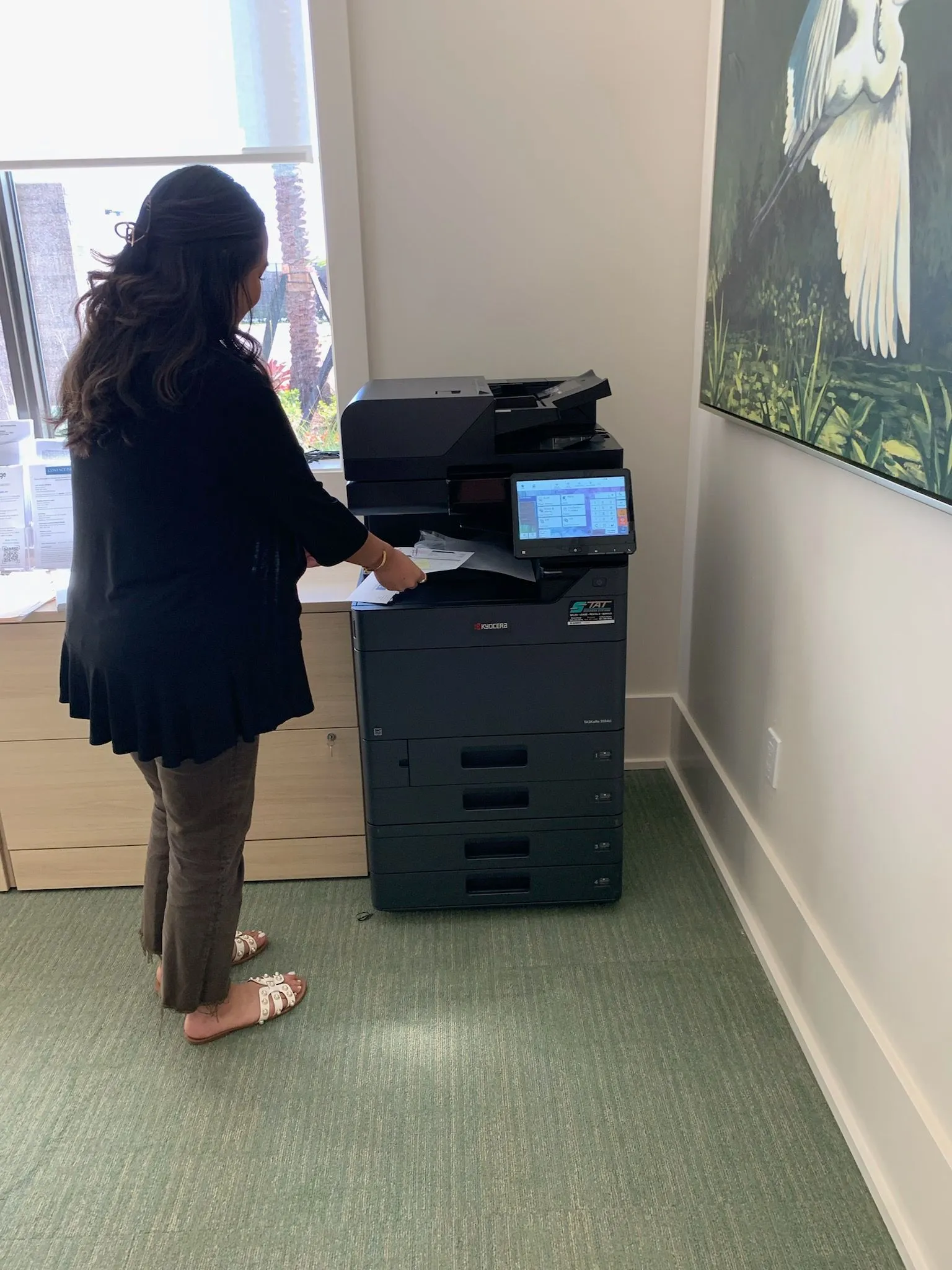 Calculator and financial documents with a copier, illustrating costs of leasing