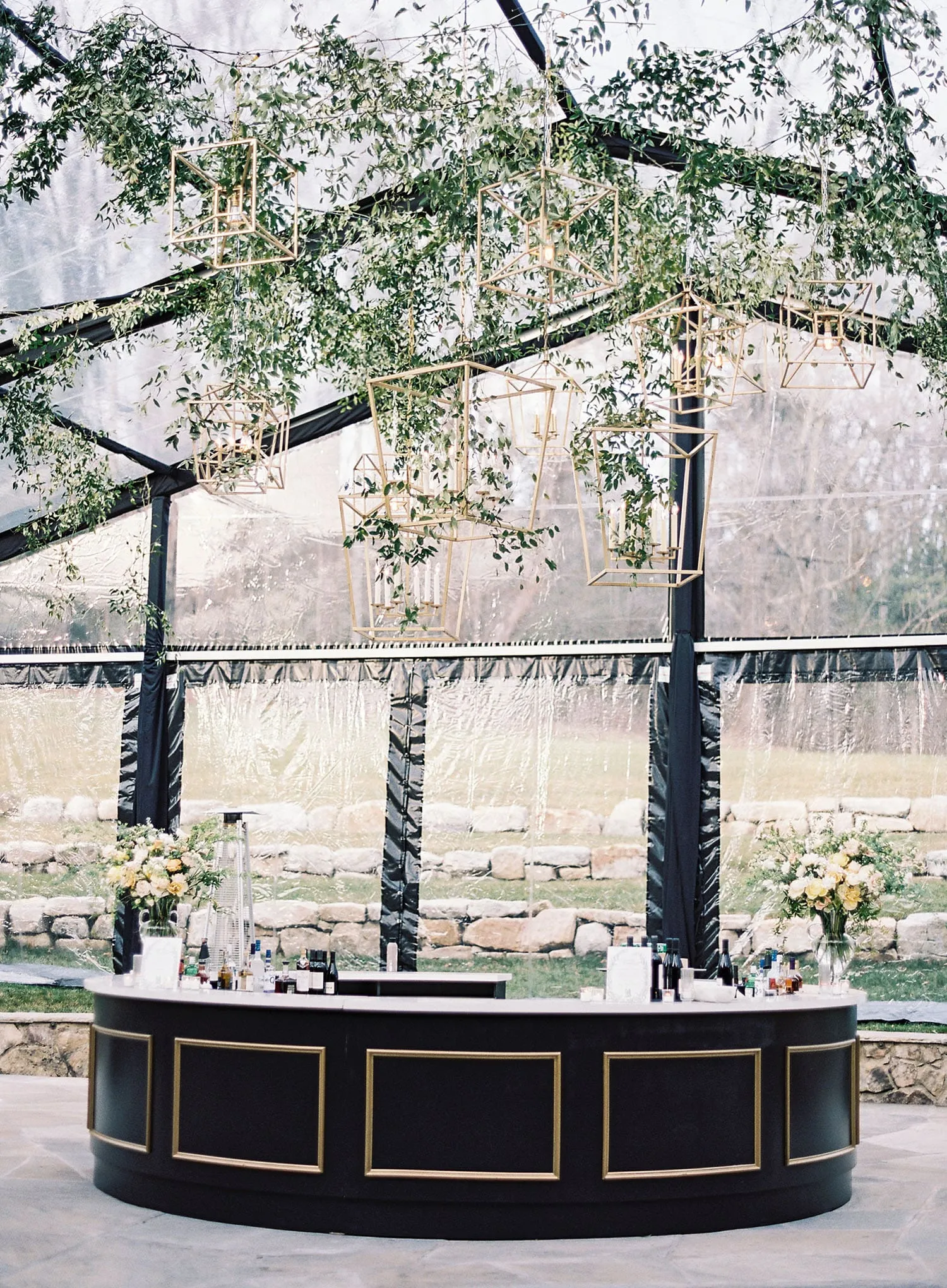 Outdoor fall wedding protected by elegant clear tent sidewalls