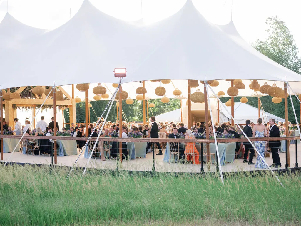 Outdoor event tent installation featuring engineered wind resistance solutions