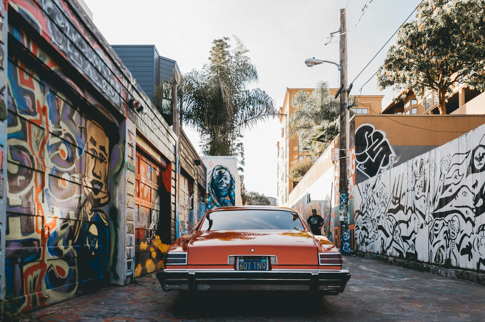 Classic car parked in a colorful San Francisco alley