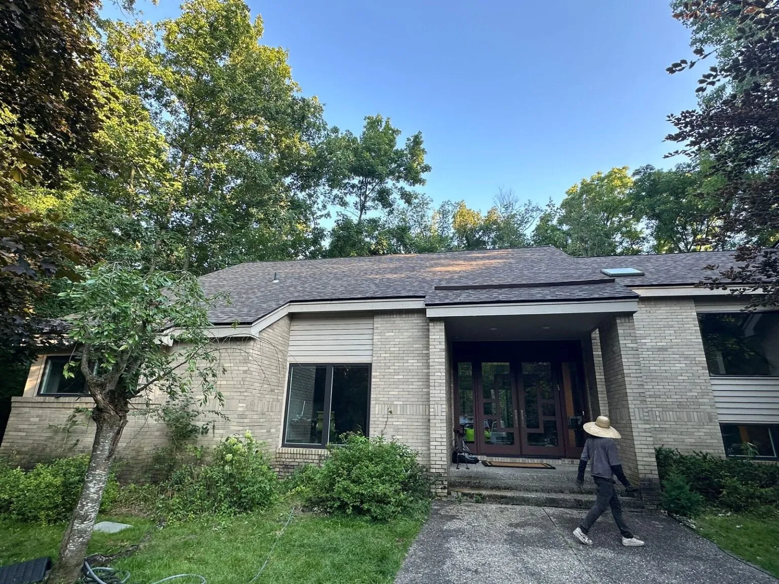 Roofing inspector examining a residential roof in Troy, Michigan