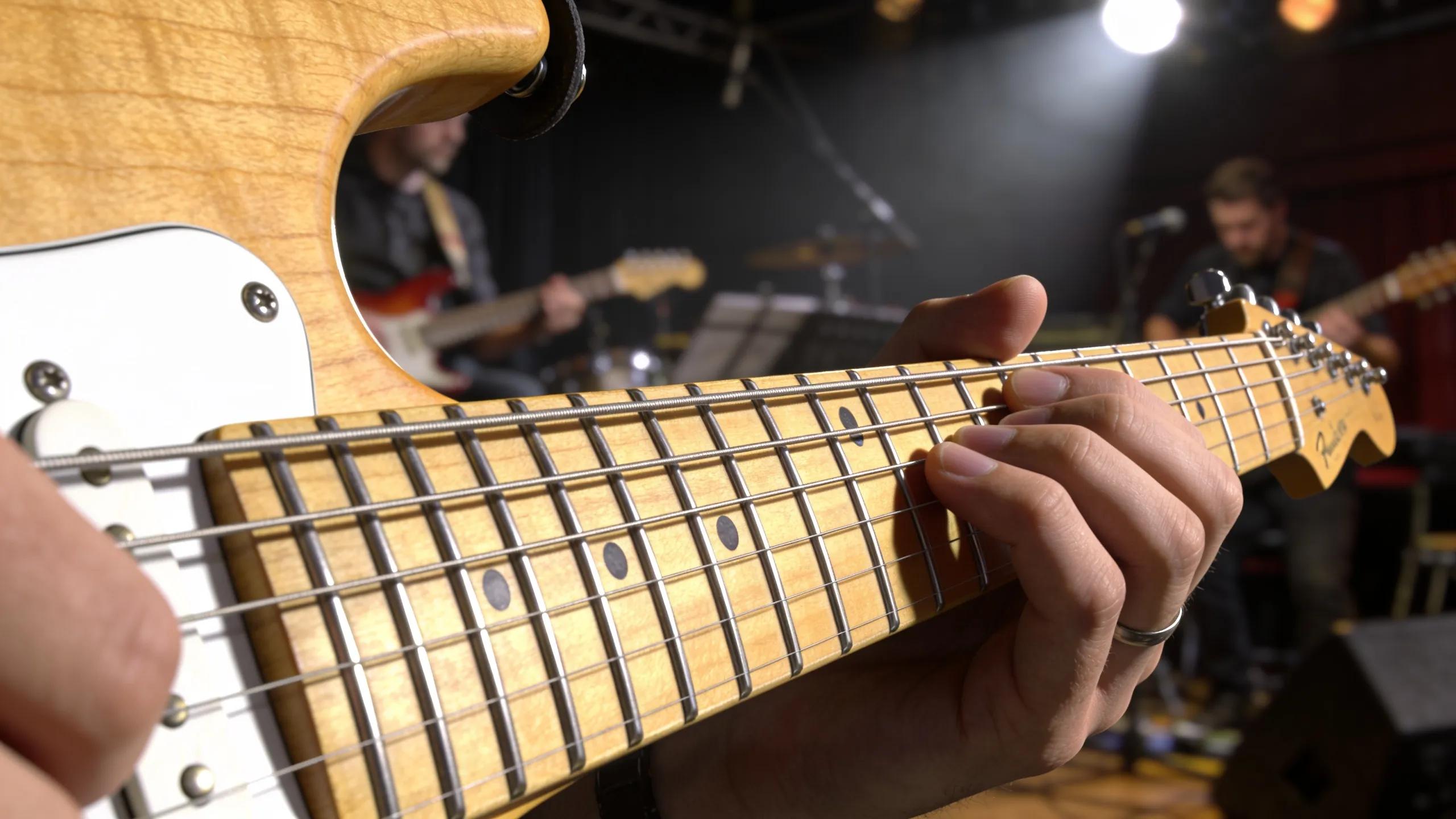 Musician's hands playing a PRS Custom 24 guitar, demonstrating ease of playability during a jam session