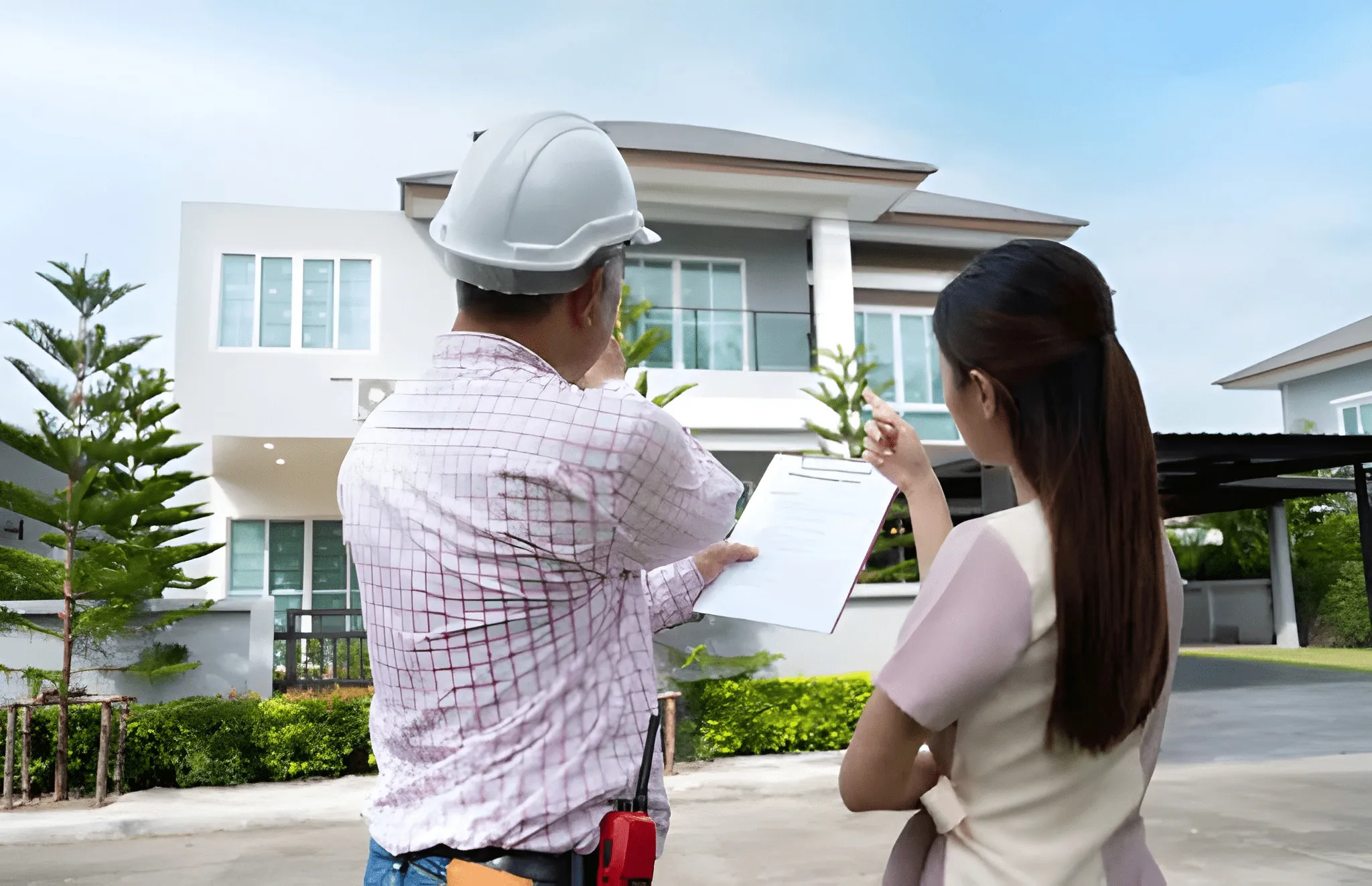 Homeowner reviewing project details and estimates with a contractor before starting roofing work Homeowner reviewing project details and estimates with a contractor before starting roofing work