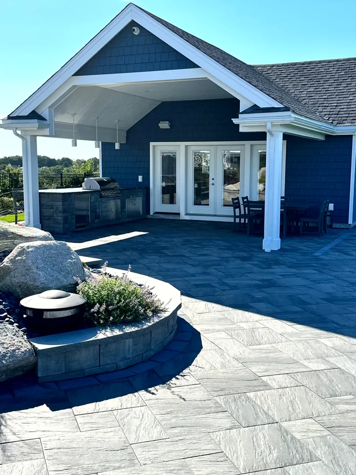 Elegant outdoor kitchen with stainless steel appliances and dining area