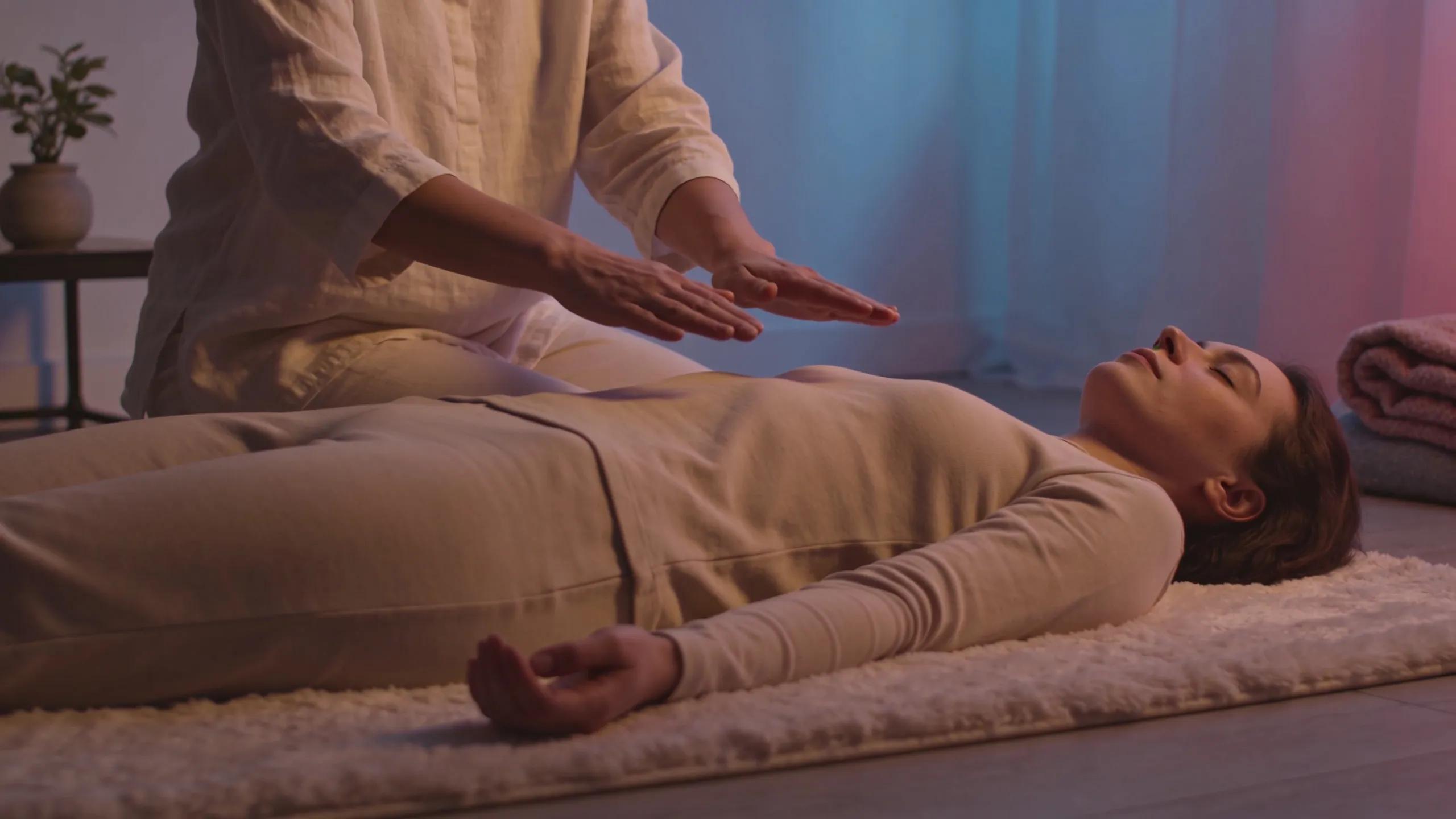 Practitioner conducting a Reiki session with client in a soothing atmosphere