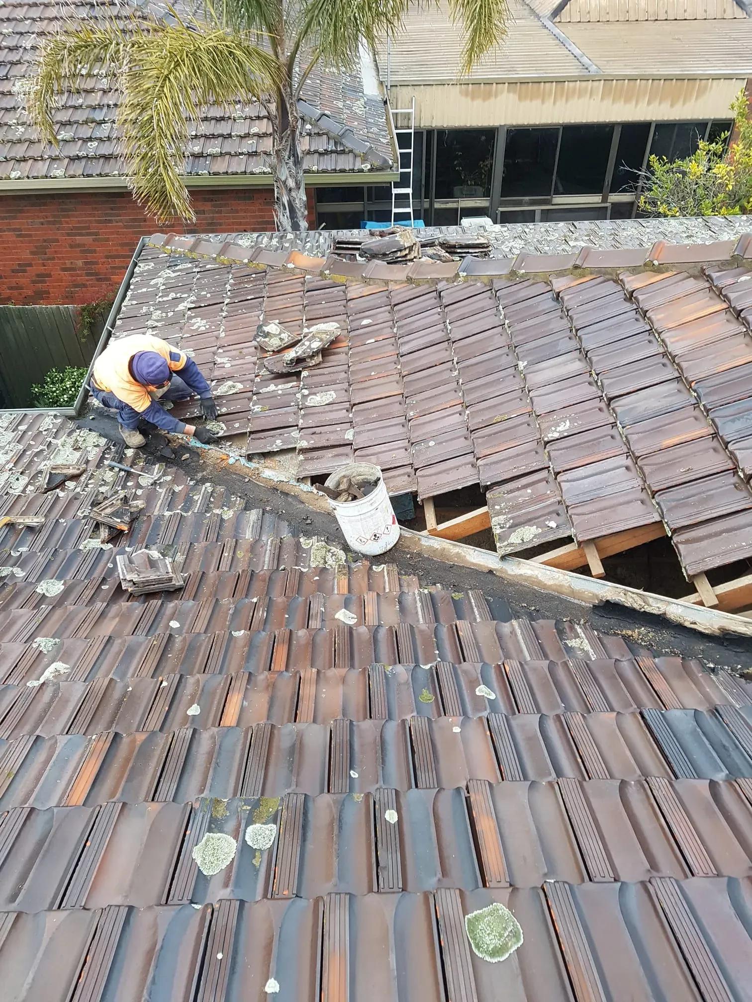 Professional roofer repairing cracked tiles on a heritage home in Essendon