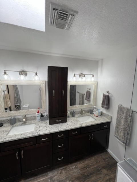 Homeowner planning bathroom remodel budget with tools and design samples