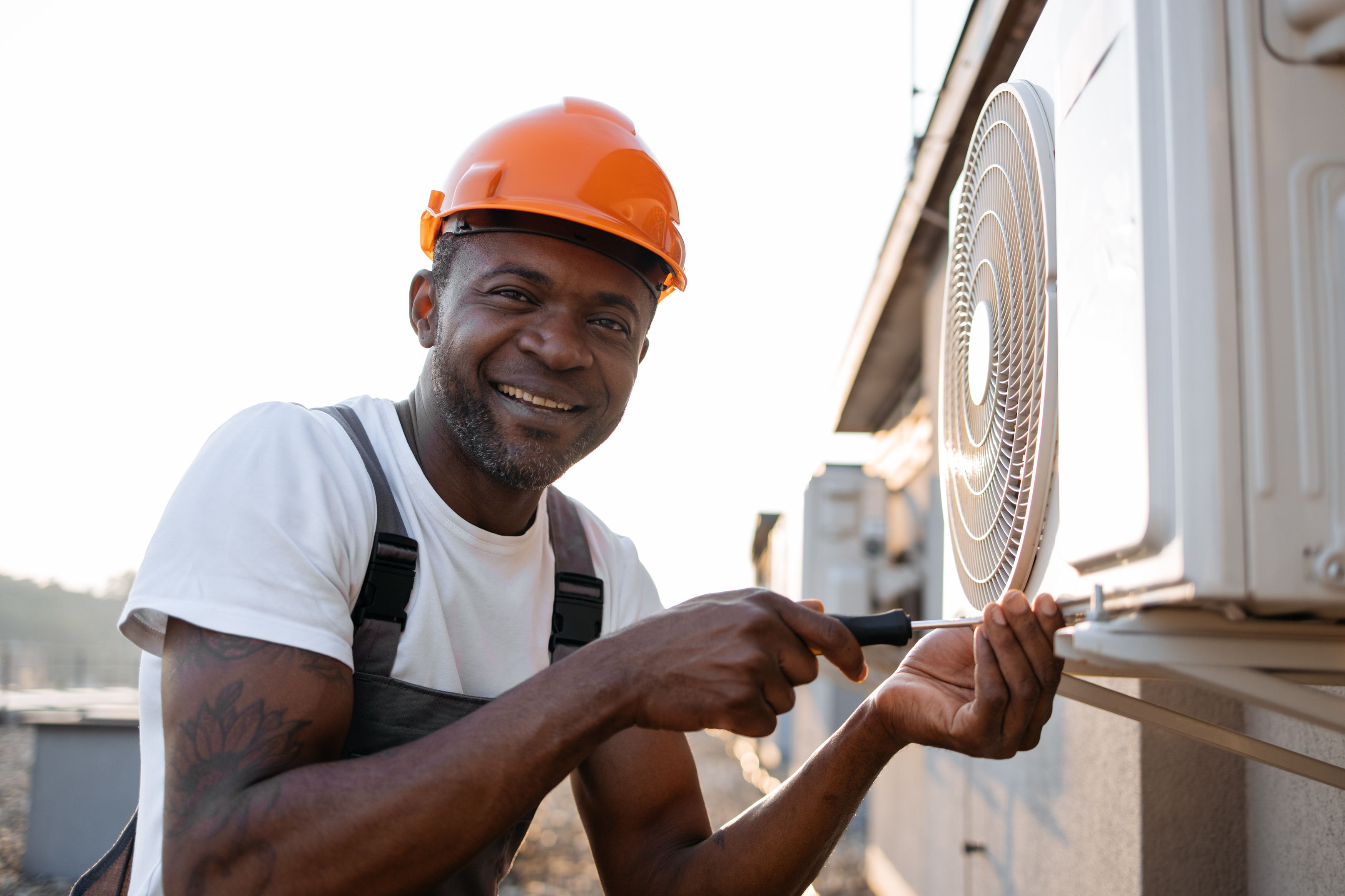 Licensed HVAC contractor installing an outdoor AC unit as part of a step-by-step professional AC installation process.